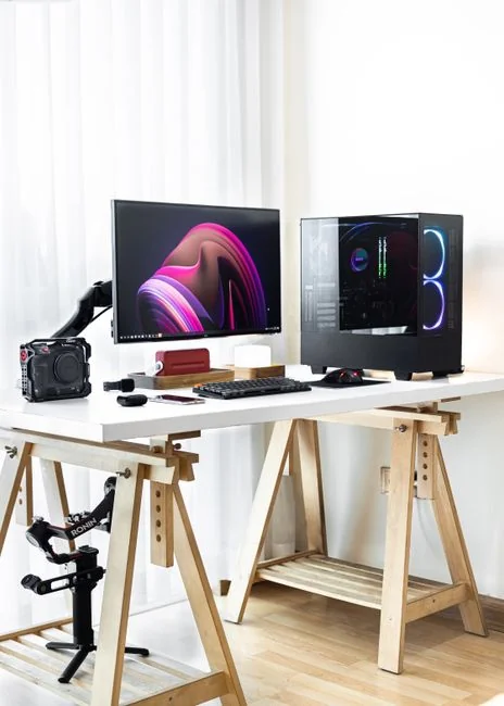 team-01 A clean and modern workspace featuring a laptop, tablet, smartphone, and monitor. Ideal for remote work and tech setups.